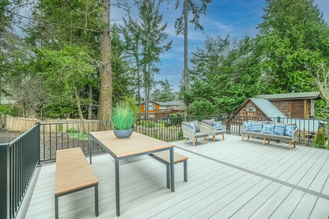 Large residential deck and wooded backyard