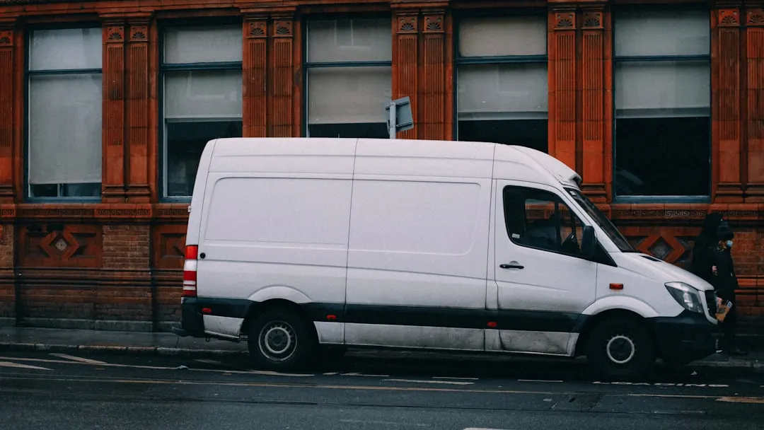 White service van in an urban neighborhood